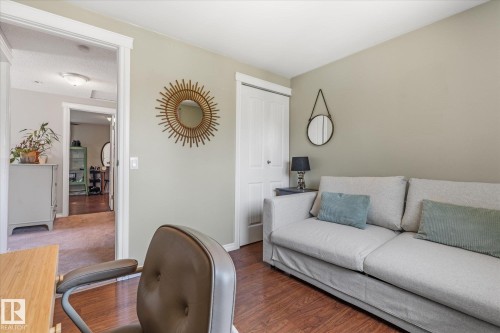 Interior room featuring wood-finish flooring, light-toned walls, white trim, and a white bi-fold closet door - 4718 35 Avenue Nw, Edmonton, AB - Indoor