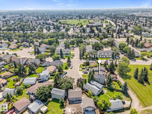 Aerial perspective showcasing a residential neighborhood with detached homes, mature trees, and paved roadways - 4718 35 Avenue Nw, Edmonton, AB - Outdoor With View