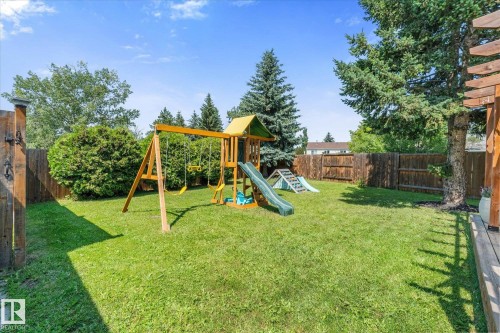 Expansive property featuring a dark shingle roof, green lawn areas, mature trees, and a paved driveway - 4718 35 Avenue Nw, Edmonton, AB - Outdoor With View