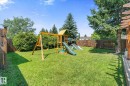 Expansive property featuring a dark shingle roof, green lawn areas, mature trees, and a paved driveway - 4718 35 Avenue Nw, Edmonton, AB  - Outdoor With View 