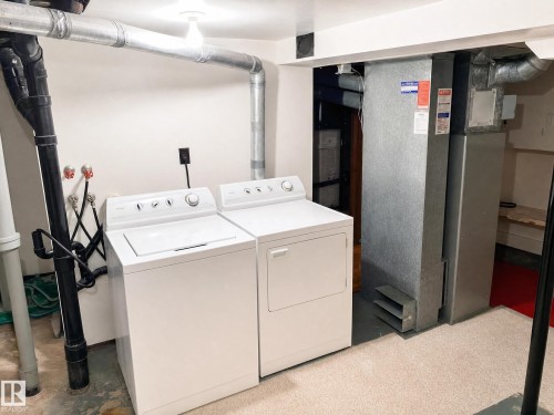 These images have been virtually decluttered to show you how this home will look once all existing furniture and personal items are removed - 11405 97 Street Nw, Edmonton, AB - Indoor Photo Showing Laundry Room