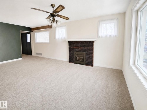 These photos are virtually decluttered to illustrate the clean, open space available to you once the current items are removed - 11405 97 Street Nw, Edmonton, AB - Indoor With Fireplace