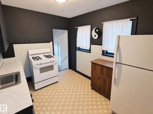 These photos are virtually decluttered to illustrate the clean, open space available to you once the current items are removed - 11405 97 Street Nw, Edmonton, AB - Indoor Photo Showing Kitchen
