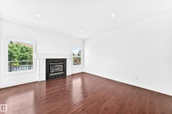 Living area featuring rich wood-finish flooring and recessed lighting - 