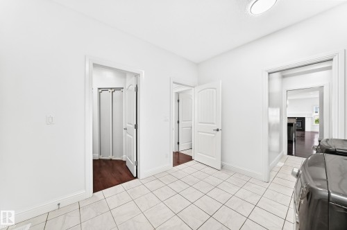 Utility area featuring white tile flooring and multiple entryways - 1663 Rutherford Road Sw, Edmonton, AB - Indoor Photo Showing Other Room