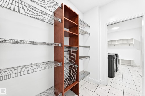 Customizable wire shelving system with a wood-finish storage unit, offering ample organization - 1663 Rutherford Road Sw, Edmonton, AB - Indoor With Storage