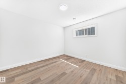 Light wood-finish flooring complements crisp white walls and white trim - 