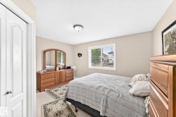 Bedroom featuring neutral wall paint and carpeting - 