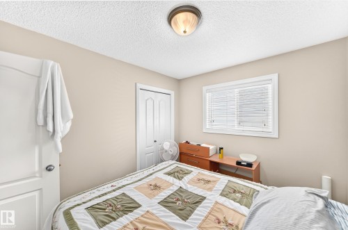 Neutral-toned walls complement the textured ceiling - 3226 30 Avenue Nw, Edmonton, AB - Indoor Photo Showing Bedroom