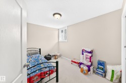 Room featuring neutral wall paint, light-colored carpeting, and a single window with horizontal blinds - 