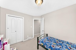 Carpeted room with light neutral wall paint and a textured ceiling - 