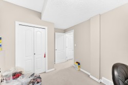 Interior hallway with neutral-toned walls, white trim, and carpet flooring - 