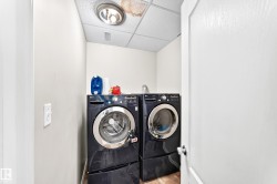 Dedicated laundry area featuring a front-loading washer and dryer set - 
