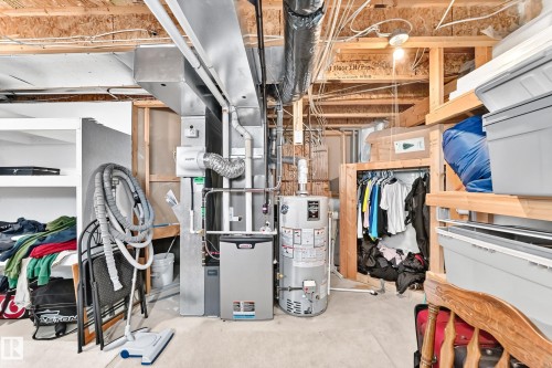 Unfinished basement featuring a concrete floor, exposed ceiling joists, and exposed ductwork - 3226 30 Avenue Nw, Edmonton, AB - Indoor Photo Showing Basement