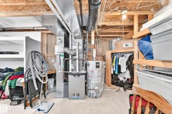 Unfinished basement featuring a concrete floor, exposed ceiling joists, and exposed ductwork - 
