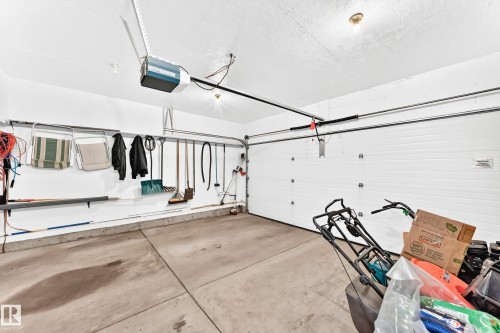 Attached garage featuring a white overhead door and concrete flooring - 3226 30 Avenue Nw, Edmonton, AB - Indoor Photo Showing Garage