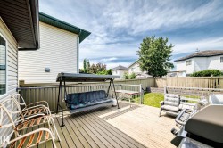 Spacious wooden deck with slatted railing - 