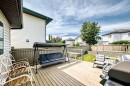 Spacious wooden deck with slatted railing - 3226 30 Avenue Nw, Edmonton, AB  - Outdoor With Deck Patio Veranda With Exterior 