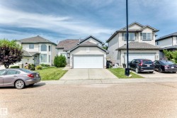 Single-family residence featuring a two-car garage, concrete driveway, and front lawn - 