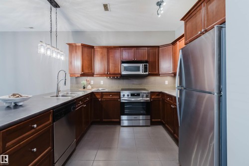 #106 160 Magrath Rd Nw, Edmonton, AB - Indoor Photo Showing Kitchen With Double Sink