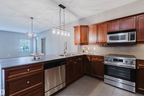 #106 160 Magrath Rd Nw, Edmonton, AB - Indoor Photo Showing Kitchen With Double Sink