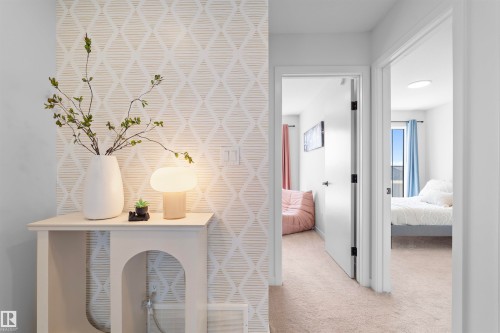 Hallway featuring patterned accent wall, light wall paint, carpet flooring, recessed lighting, and white trim - 8047 227 Street Nw, Edmonton, AB - Indoor Photo Showing Other Room
