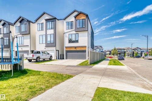 Modern residential building featuring light-colored siding and dark trim accents - 8047 227 Street Nw, Edmonton, AB - Outdoor With Facade