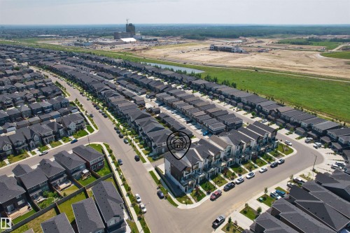 Aerial perspective showcasing a residential development with rows of detached and attached properties - 8047 227 Street Nw, Edmonton, AB - Outdoor With View