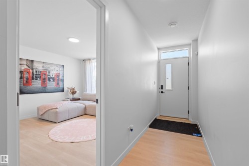 Entryway featuring a solid door with a rectangular window insert and transom window - 8047 227 Street Nw, Edmonton, AB - Indoor Photo Showing Other Room