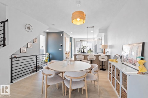 Open-concept living space with light wood-finish flooring - 8047 227 Street Nw, Edmonton, AB - Indoor Photo Showing Dining Room
