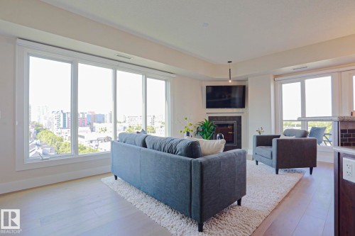 #703 10303 111 St Nw, Edmonton, AB - Indoor Photo Showing Living Room With Fireplace