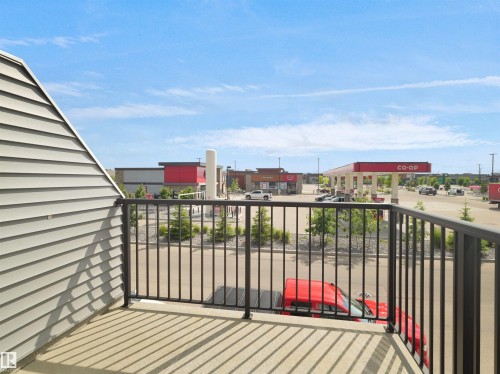 Balcony featuring a concrete surface and black metal railings - #81 6905 25 Av Sw, Edmonton, AB - Outdoor With Balcony