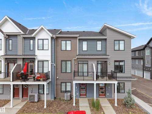 Modern townhome exteriors featuring multi-toned siding, black-framed windows, and private balconies - #81 6905 25 Av Sw, Edmonton, AB - Outdoor With Balcony With Facade