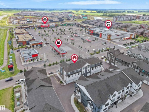 Modern residential buildings featuring contemporary architecture, dark shingled roofs, and private balconies - #81 6905 25 Av Sw, Edmonton, AB - Outdoor With View