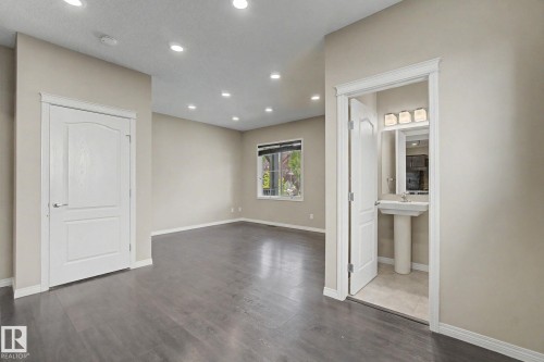 Bright interior space featuring wood-finish flooring, recessed lighting, and a neutral wall palette - 315 Watt Boulevard Sw, Edmonton, AB 