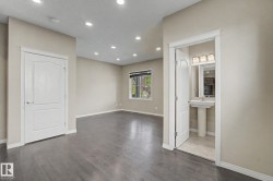 Bright interior space featuring wood-finish flooring, recessed lighting, and a neutral wall palette - 