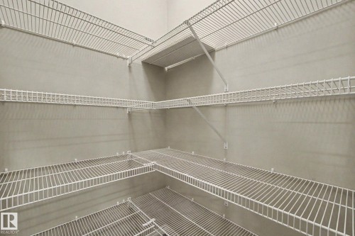 Expansive storage area featuring multiple tiers of white wire shelving, providing ample organizational solutions - 315 Watt Boulevard Sw, Edmonton, AB 