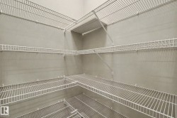 Expansive storage area featuring multiple tiers of white wire shelving, providing ample organizational solutions - 