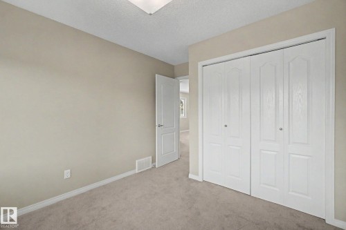 Room featuring light neutral wall paint, white baseboards, and wall-to-wall carpeting - 315 Watt Boulevard Sw, Edmonton, AB 