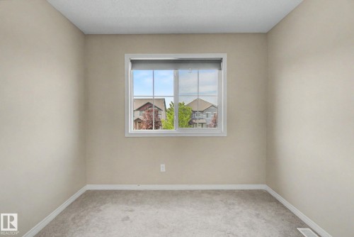 Neutral-toned walls complement the light gray carpeting - 315 Watt Boulevard Sw, Edmonton, AB 