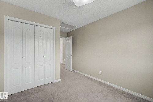 Room featuring neutral-toned walls, white trim, and carpeting - 315 Watt Boulevard Sw, Edmonton, AB 