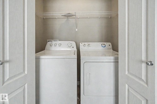 Dedicated laundry closet featuring a top-load washer, front-load dryer, and an overhead wire shelving unit - 315 Watt Boulevard Sw, Edmonton, AB 