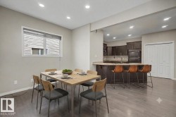 Dining area featuring wood-finish flooring, recessed lighting, and a window with blinds - 