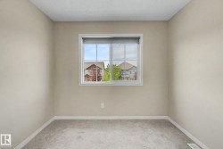 Neutral-toned walls complement the light gray carpeting - 