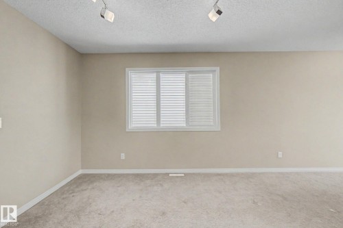 Neutral-toned walls complement the light-colored carpet, creating a bright interior space - 315 Watt Boulevard Sw, Edmonton, AB 