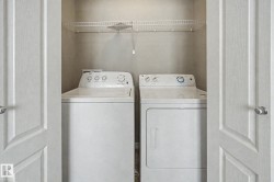 Dedicated laundry closet featuring a top-load washer, front-load dryer, and an overhead wire shelving unit - 