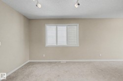 Neutral-toned walls complement the light-colored carpet, creating a bright interior space - 