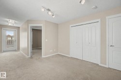 Carpeted room with neutral wall tones and a white bi-fold closet - 