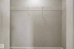 Closet space featuring a wire shelving system and a neutral wall color - 