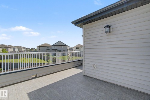 Spacious outdoor deck featuring wood-finish composite decking and white railing - 315 Watt Boulevard Sw, Edmonton, AB 